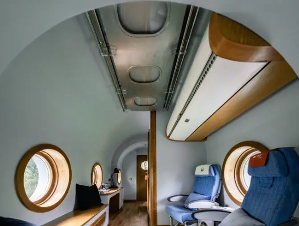 An airplane-shaped tiny home built from the Woods' in the Woods